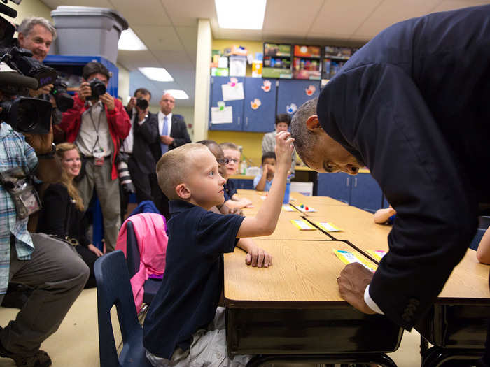 The president lets this first grader touch up his hairdo.