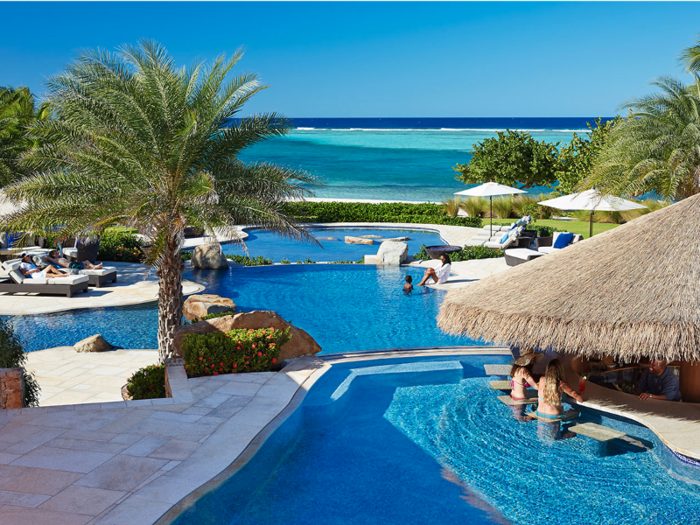 At Oil Nut Bay in Virgin Gorda of the British Virgin Islands, three recycled-glass pools are steps from the white sand beaches. Divided for different generations, the "adult" pool has a swim-up bar.