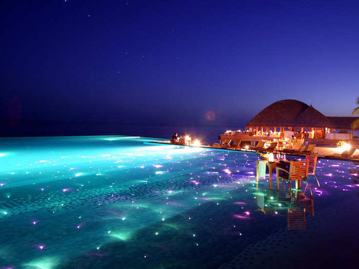 For a breathtaking evening swim, go to the Huvafen Fushi resort in the Maldives where the pool is covered in colored lights that twinkle beneath the surface.