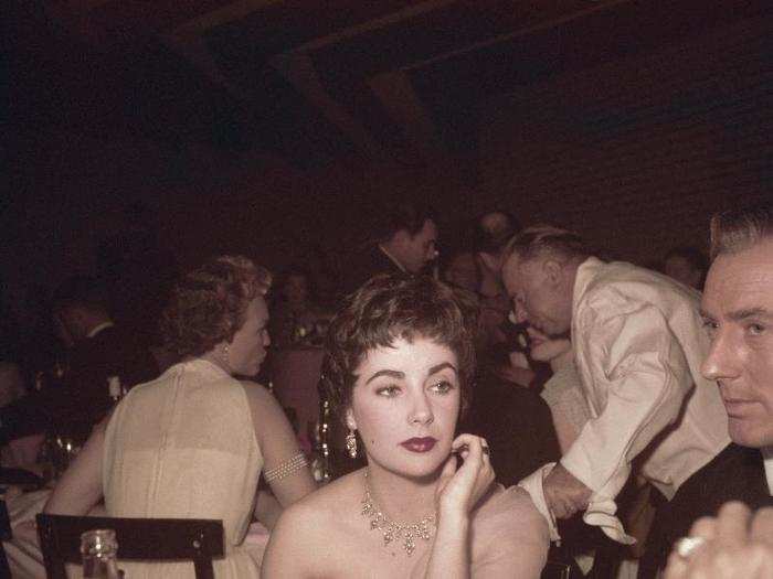 Elizabeth Taylor with her husband, British actor Michael Wilding, at the 26th Academy Awards in 1954.