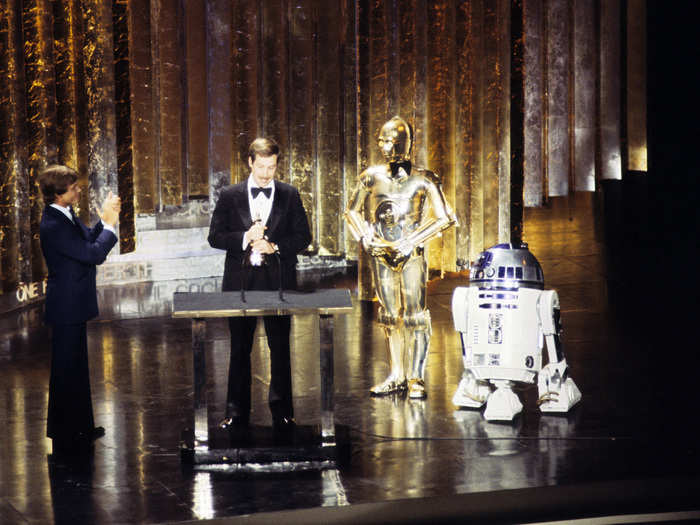 C-3PO in a bowtie and R2-D2 join Mark Hamill and "Star Wars" sound designer Benjamin Burtt, Jr. at the 1978 Oscars after the film was released.