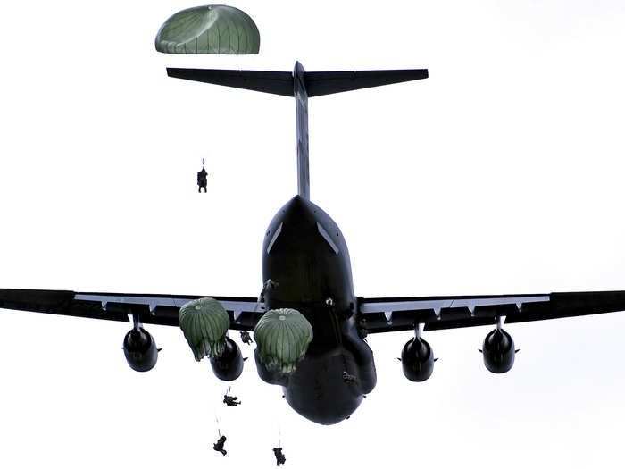 Paratroopers jump from a C-17 Globemaster III over Malamute Drop Zone, Tuesday, June 4, 2013.