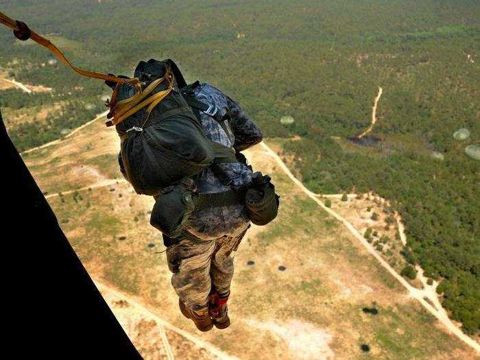 A US Army paratrooper from the 330th Transportation Brigade performs an airborne insertion from a C-17 Globemaster III cargo aircraft.