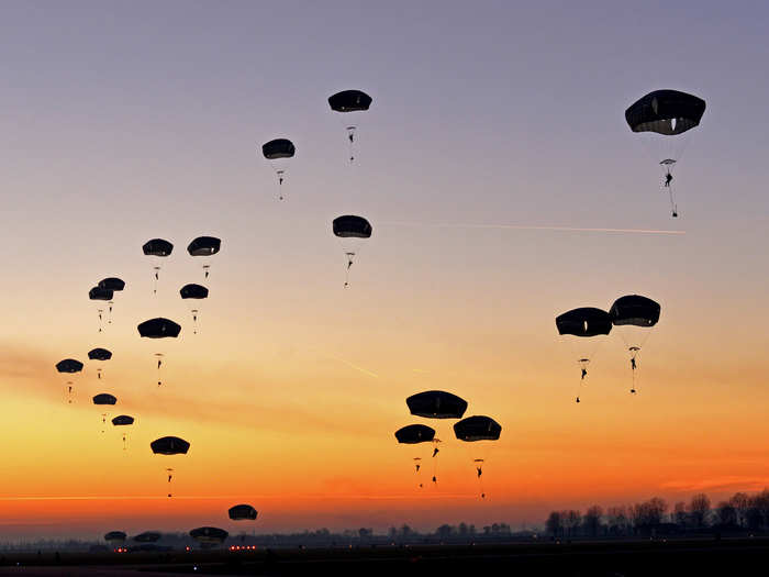 Paratroopers from 1st Batallion, 503rd Infantry Regiment and 173rd Airborne Brigade Combat Team, prepare to land after jumping from a C-130 Hercules .