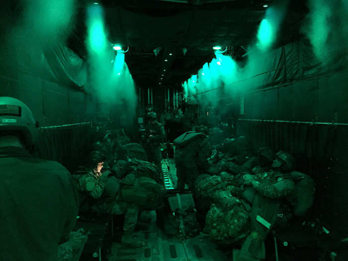 US Army paratroopers wait patiently aboard a C-130H Hercules for their time to jump.