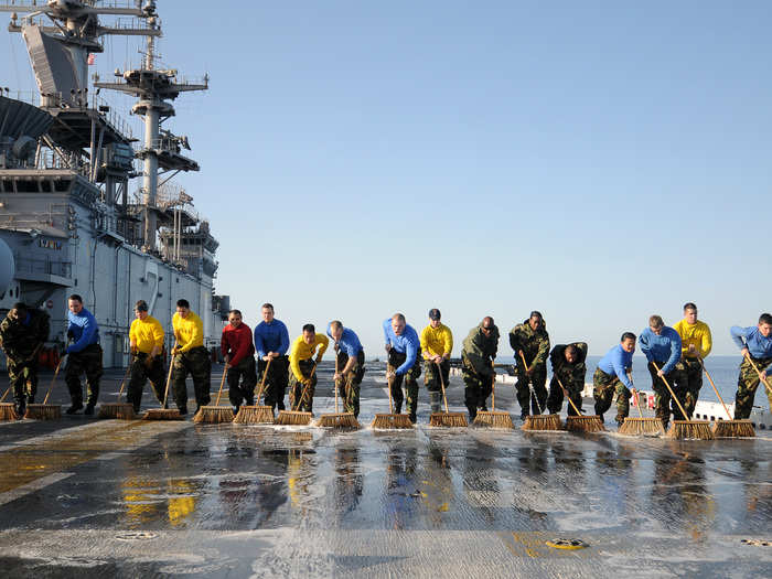 SS Essex Sailors scrub the flight deck.