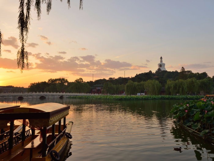 At Beihai Park, you can rent quaint rowboats to take in views of pavilions and towers nestled among lakes, hills, and lush greenery.