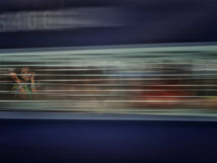 A girl rides the train in India.