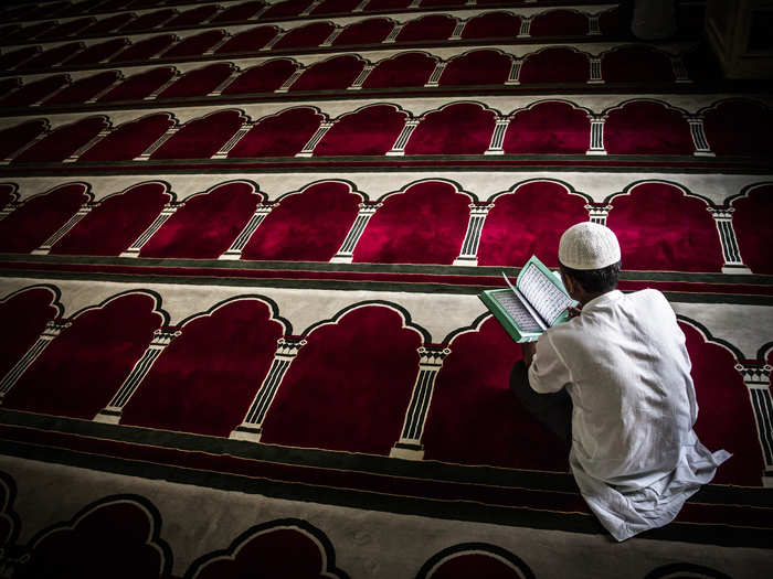 A man reads the Koran, Islam