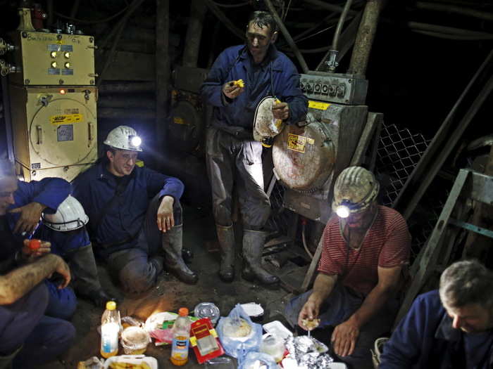 Coal miners eat as they break their fast during the holy month of Ramadan, 740 meters (2,427 feet) deep inside the Stara Jama coal mine, in Zenica, Bosnia and Herzegovina, July 15, 2015.