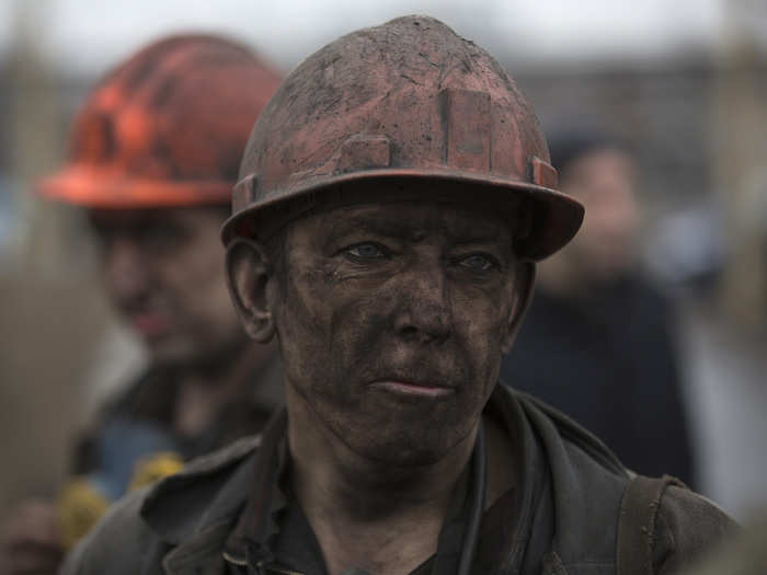 A miner waits for a bus after leaving Zasyadko coal mine in Donetsk, March 4, 2015. Dozens of miners were trapped underground and feared dead after a blast on Wednesday at a coal mine in the eastern Ukrainian rebel stronghold of Donetsk, with rescuers saying the chance of finding many survivors was slim.