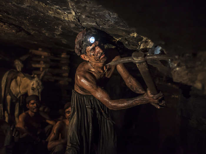 Miner Mohammad Ismail, 25, digs in a coal mine in Choa Saidan Shah, Punjab province, Pakistan, April 29, 2014.