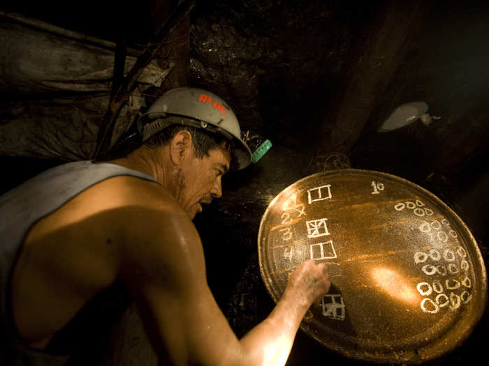 A coal miner registers the quantity of coal produced by each miner on an improvised chalkboard inside an artisanal mine, or "pocito," at the town of Nueva Rosita, Mexico, July 31, 2008. The mines, called "pocitos" or "little holes" and known for their rudimentary and often dangerous mining techniques, were trying to boost output as prices for imports soared and Mexico looked for more local coal to power up its electricity grid. Record high prices for fuel oil had pushed the country