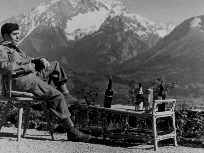 A paratrooper of the 101st Airborne Division enjoys the view and a cognac while lounging on the terrace of Hitler