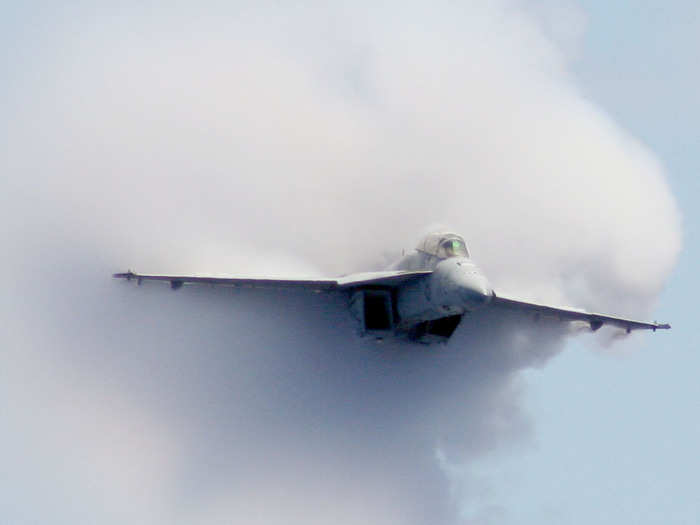 Capt. Norbert "Smurf" Szarleta, commanding officer of Carrier Air Wing 17, breaks the sound barrier in an F/A-18F Super Hornet strike fighter during an air power demonstration aboard the aircraft carrier USS George Washington.