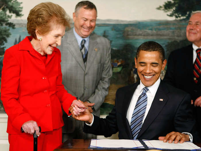 In 2009, President Obama signed the Ronald Reagan Centennial Commission Act — a law to develop and carry out activities that honor the memory of Ronald Reagan. Nancy was present as Obama signed the act.