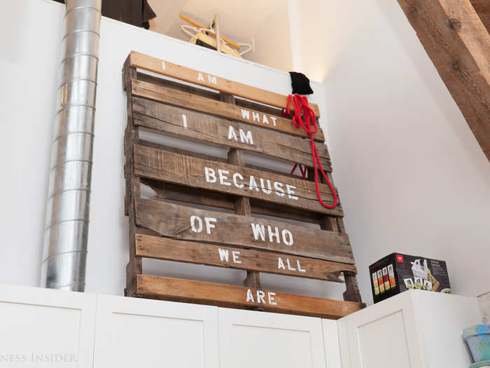 At the core of her business and her worldview is a belief in equal opportunity for women and the importance of each person fulfilling their potential. She chose this Ubuntu saying, "I am what I am because of who we all are," and painted it on a piece of scrap wood she sanded and stained herself before putting it up above her kitchen.