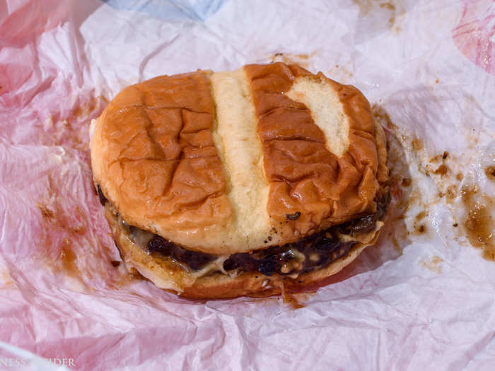 There are myriad problems with this burger. The patty is burned, the bun is soggy, and the Swiss cheese is half-way melted on one side of the burger.