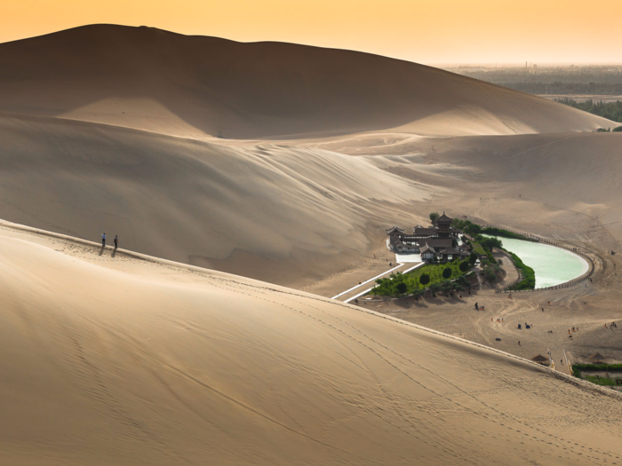 The Crescent Lake (or "Yueyaquan" in Chinese) is a fresh water spring in the shape of a half moon that sits in the Gobi Desert. The oasis is believed to have existed for around 2,000 years (though it has seen its water levels decline), and attractions include activities like dune surfing and camel riding.