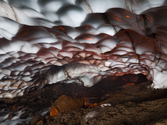 Ice caves that reside within Kamchatka, Russia, come complete with stunning formations and hues of purples, blues, greens, and yellows, which arise when sunlight streams through their glacial ice.