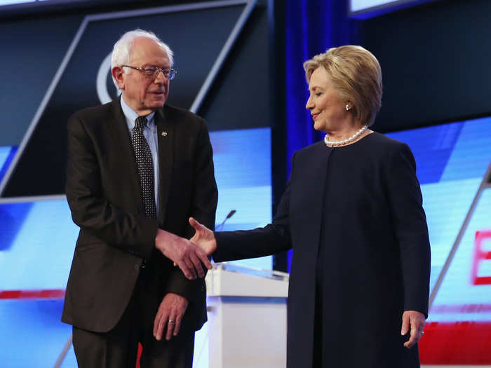 Democratic presidential candidates Senator Bernie Sanders (D-VT) and Hillary Clinton shake hands before the Univision News and Washington Post Democratic Presidential Primary Debate on the Miami Dade College