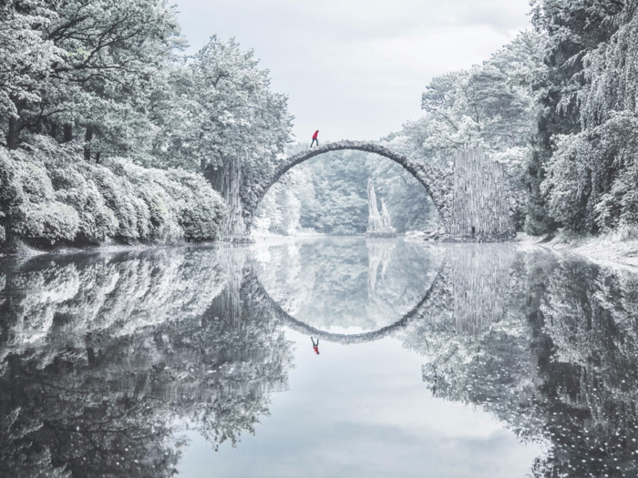 "Nestled deep in the woods on the eastern German border lies Rakotzbrücke. Its perfectly constructed arch allows the re?ection to create a complete circle, mirroring the bridge and its surroundings to create the feel of a new world beneath the surface. Walking in the freezing cold through eerie forests and desolate villages to ?nd this bridge made the whole experience one that will live in my mind forever."— @jacob