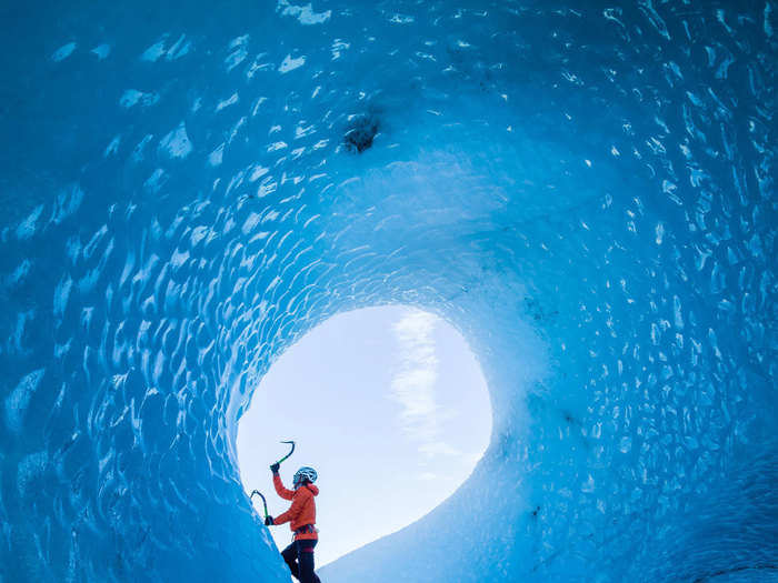 "This is a photo of my good friend Klemen Premrl climbing the inside of an iceberg in Iceland. Being that it was Iceland, it meant the conditions were constantly changing, but a moment of calm was enough for me to capture this shot of Klemen in action." — @timkemple