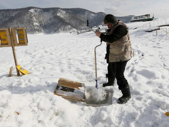 To get fresh water for drinking and cooking, some people outside of Krasnoyarsk, near Siberia, Russia have to break through frozen surfaces.