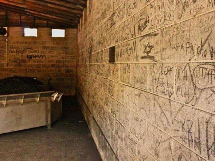 Extra charcoal is held in this room where employees have playfully tagged the walls.