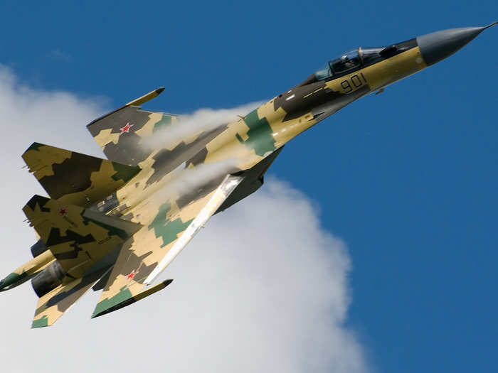 A Russian Su-35 Super Flanker soars through the clouds.