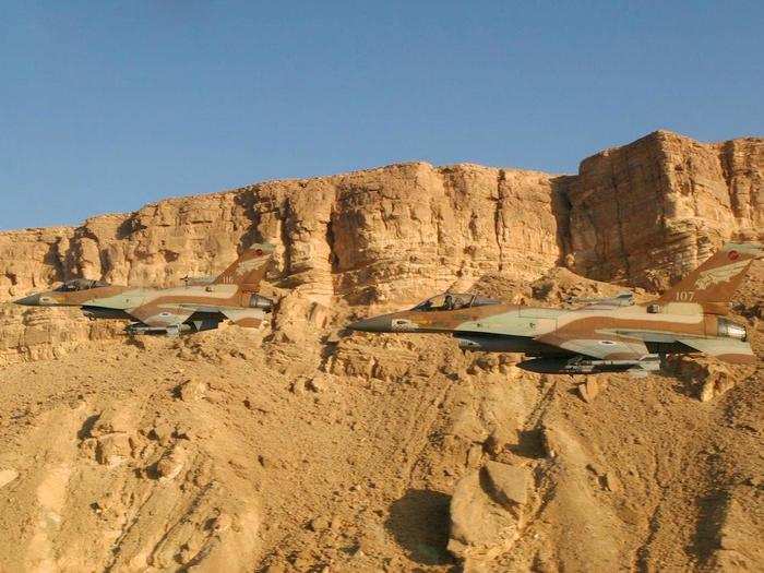 Israeli F-16s fly low and fast inside the Ramon Crater in the Negev Desert, Israel.