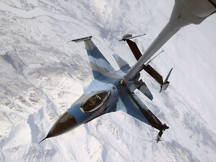An F-16 Fighting Falcon showing the aggressor paint scheme disconnects from a KC-10 Extender after being refueled during a Red Flag-Alaska exercise April 22 and is ready to re-engage the friendly forces.