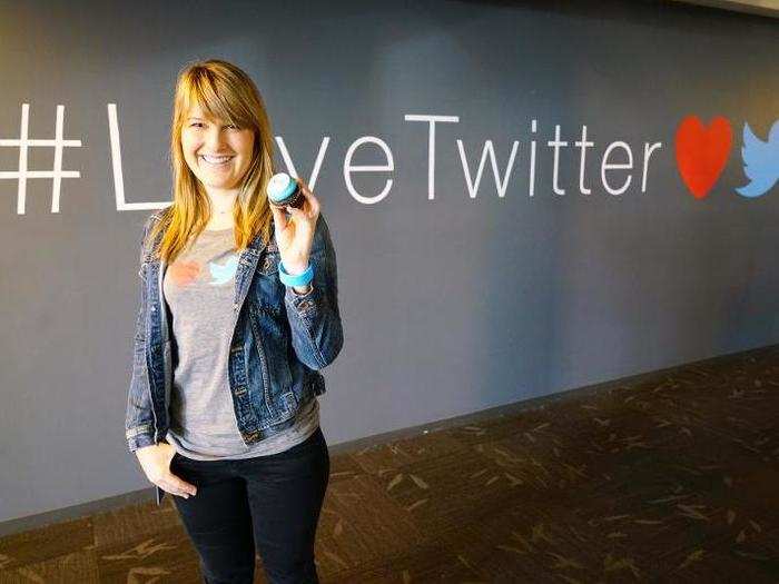 Internal communications head Libby Laveson (@libby) in front of the #LoveTwitter hashtag display.