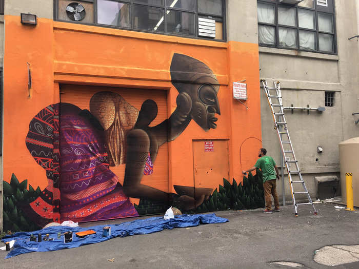 Brazilian artist Alexandre Keto puts up stylized murals like this one in Long Island City, drawing attention to race and class issues.