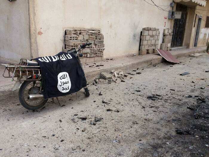 A flag belonging to the Islamic State fighters is seen on a motorbike, after the city was retaken by Syrian and Russian forces.