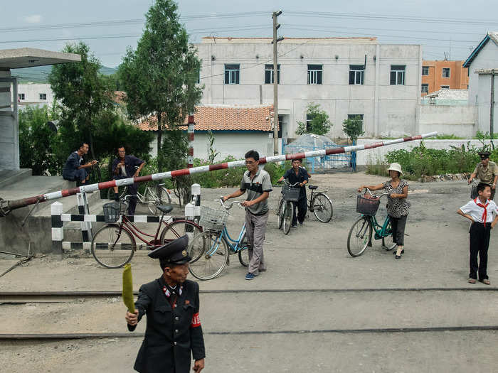 Many people rode bicycles, as seen at a railway crossing en route.