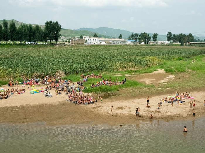 Some scenes were quaint. Children took an afternoon dip in a river.