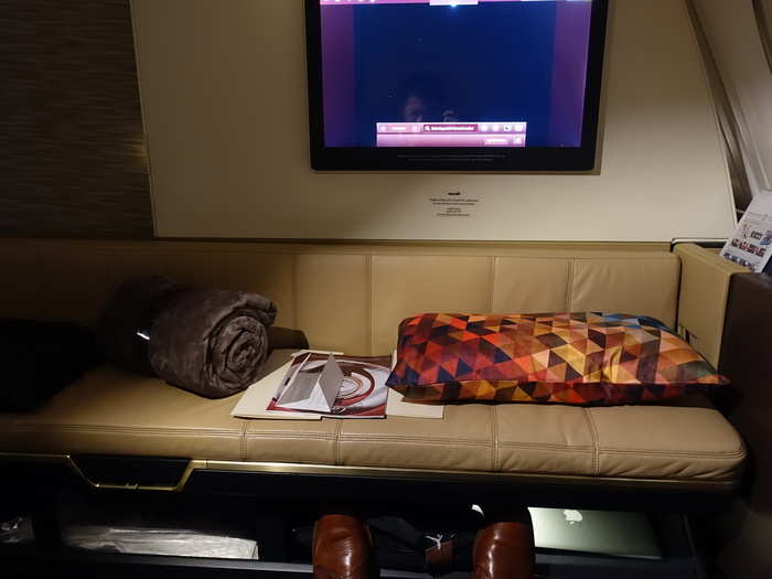 Underneath the vanity mirror is a minibar filled with soft drinks and bottled water. Adjacent to the mirror is a small closet where you can hang your clothes.

Like Emirates, the overhead storage has been removed to give the space a more airy feeling. Storage of baggage is located under the bench instead.