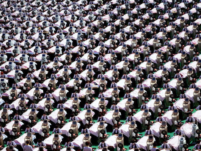 Here, a group of 1,000 customers receive a facial massage at a sports center in Jinan, Shandong province, China.