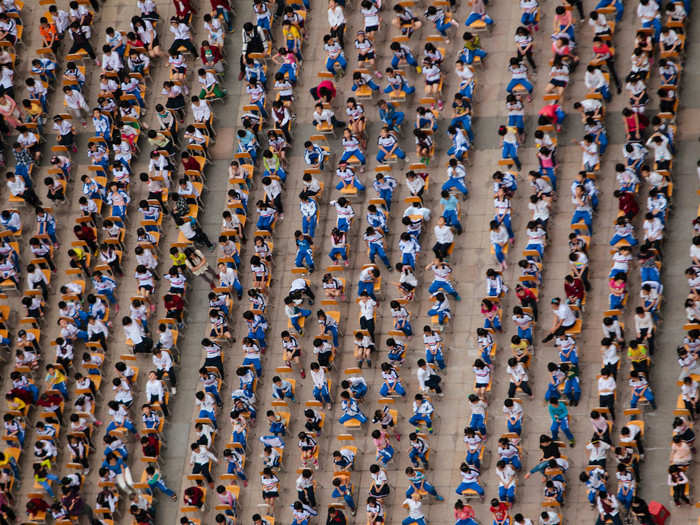 Many schools combine lessons due to the size of the classes. Pictured below, combined classes attend an outdoor joint lesson in Guangzhou, Guangdong province.