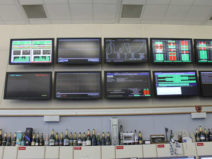 Working in the Control Center is intense, but when the team pulls off a big accomplishment, they celebrate with champagne. The empty bottles line the cabinet tops under this wall of screens.