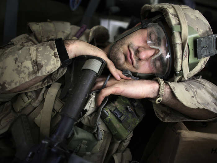 A Canadian soldier takes a nap after taking part in a search operation for improvised explosive devices (IEDs) in Kandahar May 21, 2009.