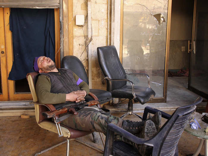 A member of the Free Syrian Army sleeps with his weapon on his lap in the city of Aleppo February 26, 2013.