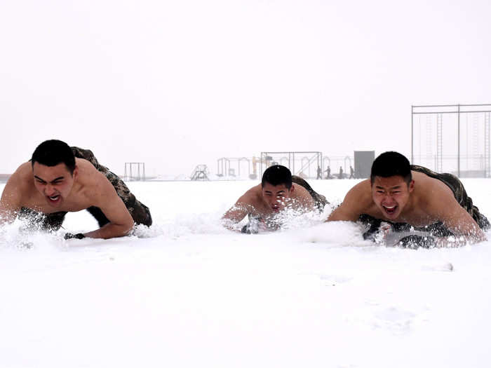 During winter training, they are required to take off their shirts and crawl through the snow.