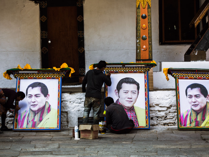 In the 1970s, Bhutan rejected the GDP as the only way to measure success, deciding to go with what they call Gross National Happiness instead. Jigme Singye Wangchuck, or "K4" as he is sometimes known, is the monarch who introduced the concept. Pictured here are workers preparing portraits of K4 and his son, current King Jigme Khesar Namgyel Wangchuck, for K4