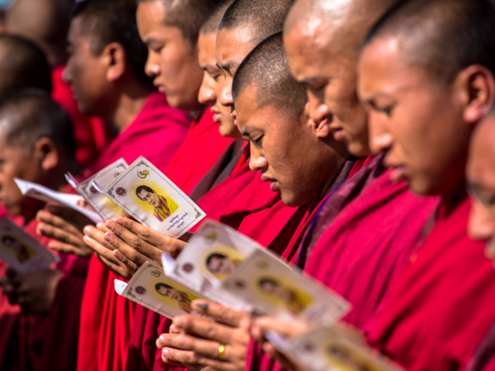 "It is stunning to see how many people attribute their happiness to these two kings," Weir said. Pictured here are monks celebrating the king