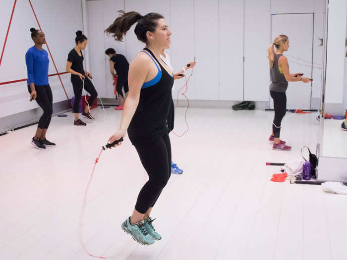 This is me, preparing for class by reminding myself how to jump rope. The Aerospace studio is a massive, brightly lit mirrored space; no candlelight vibes here. Some classes take place in a basement room outfitted with punching bags, but "Aero3" is out in the open.