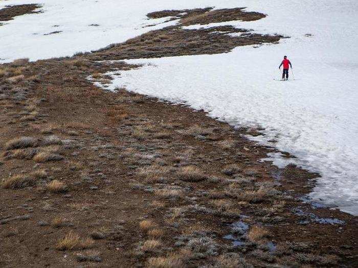 A skier approaches the edge of the snow at Lake Tahoe in March.