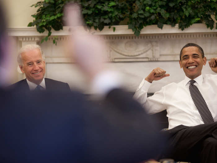 Obama and Biden react during a lighter moment at the daily economic briefing in the Oval Office on July 30, 2009.