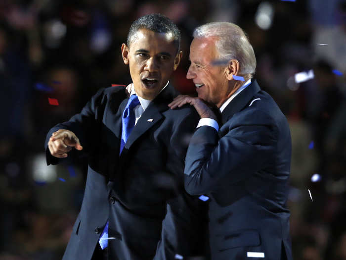 Obama gestures with Biden after his election night victory speech in Chicago on November 6, 2012.
